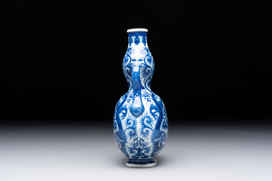 A rare and fine Chinese blue and white double gourd 'dragon' vase with ruyi handles, Qianlong mark and of the period