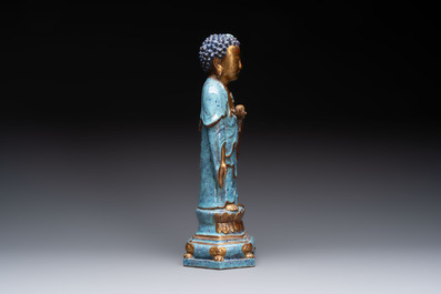 A Chinese robin's egg-glazed gilt-decorated standing Buddha, 18th C.