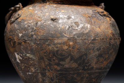 A rare Chinese parcel-gilt silver handled jar with floral scroll design, Tang