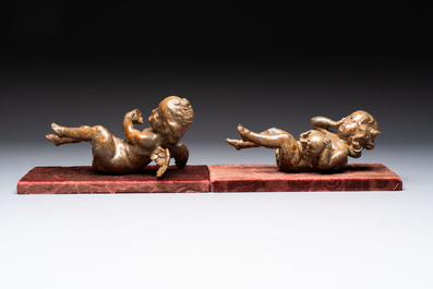 A pair of Flemish allegorical carved wood cherubs, 17th C.