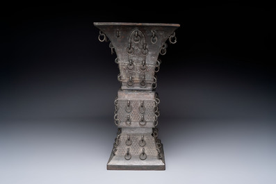 A large Chinese bronze quadrangular 'gu' vase with hanging rings, Ming