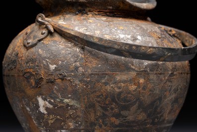 A rare Chinese parcel-gilt silver handled jar with floral scroll design, Tang