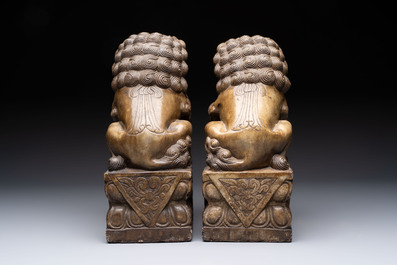 A pair of Chinese carved stone Buddhist lions, a large seal and a wooden box with four seals, 20th C.