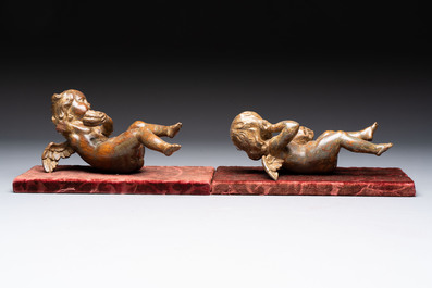A pair of Flemish allegorical carved wood cherubs, 17th C.