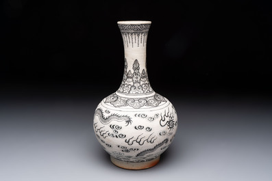 A Chinese black-enamelled biscuit 'dragon' vase, Kangxi mark, 19th C.