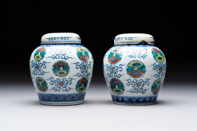 A pair of Chinese doucai 'chrysanthemum' jars and covers, Daoguang mark and of the period
