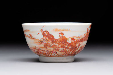 A Chinese iron-red-decorated 'Deer Hunting' cup and saucer, Qianlong