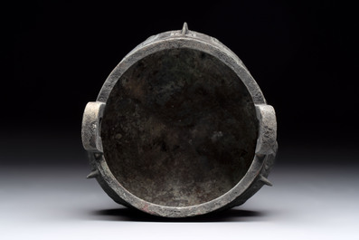 A Chinese archaic bronze tripod food vessel with 'taotie' design, 'ding 鼎', Western Zhou