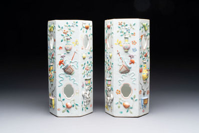 A pair of Chinese famille rose relief-moulded reticulated 'antiquities' hat stands, 19th C.