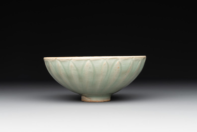 A Chinese Longquan celadon 'lotus' bowl and a large green-glazed Shiwan jar, Ming and later