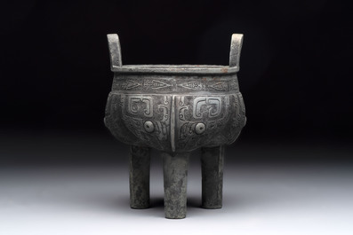 A Chinese archaic bronze tripod food vessel with 'taotie' design, 'ding 鼎', Western Zhou