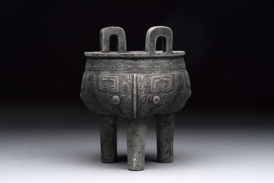 A Chinese archaic bronze tripod food vessel with 'taotie' design, 'ding 鼎', Western Zhou
