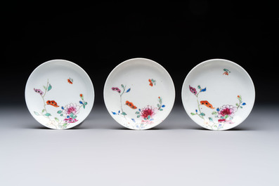 Seven Chinese famille rose cups and eleven saucers with floral design, Qianlong