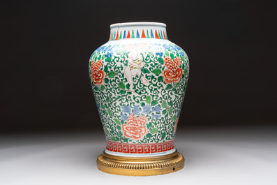 A Chinese wucai 'He He Er Xian' vase on gilt-bronze stand, 19th C.