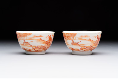 A Chinese iron-red-decorated 'Deer Hunting' bowl and two cups, Qianlong