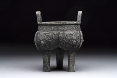 A Chinese archaic bronze tripod food vessel with 'taotie' design, 'ding 鼎', Western Zhou