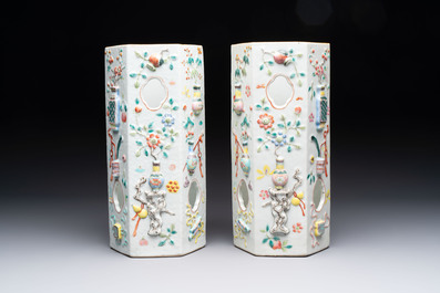 A pair of Chinese famille rose relief-moulded reticulated 'antiquities' hat stands, 19th C.