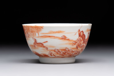 A Chinese iron-red-decorated 'Deer Hunting' cup and saucer, Qianlong