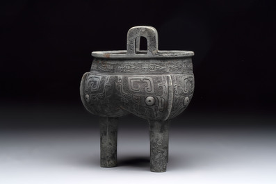 A Chinese archaic bronze tripod food vessel with 'taotie' design, 'ding 鼎', Western Zhou