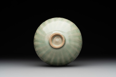 A Chinese Longquan celadon 'lotus' bowl and a large green-glazed Shiwan jar, Ming and later