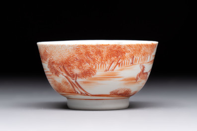 A Chinese iron-red-decorated 'Deer Hunting' cup and saucer, Qianlong