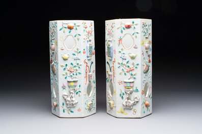 A pair of Chinese famille rose relief-moulded reticulated 'antiquities' hat stands, 19th C.