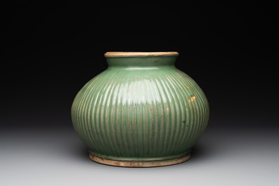 A Chinese Longquan celadon 'lotus' bowl and a large green-glazed Shiwan jar, Ming and later