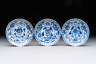 A set of six Chinese blue and white cups and saucers with floral design, Kangxi