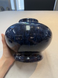 A Chinese flamb&eacute;-glazed vase on a wooden stand, 19th C.
