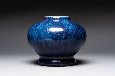 A Chinese flamb&eacute;-glazed vase on a wooden stand, 19th C.