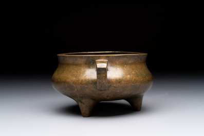 A Chinese bronze two-handled tripod censer, 19th C.