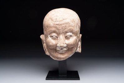 A Chinese sandstone head of a Luohan, Ming