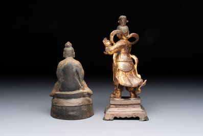 A Chinese bronze Taoist figure and a gilt-lacquered guardian, Ming