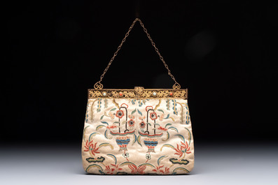 A Chinese embroidered silk purse with red coral- and turquoise-inlaid gilt-bronze mounts, Qing