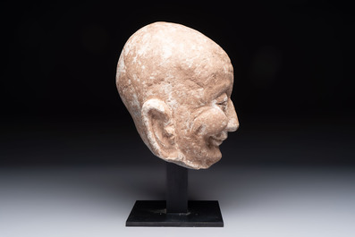 A Chinese sandstone head of a Luohan, Ming