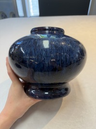 A Chinese flamb&eacute;-glazed vase on a wooden stand, 19th C.