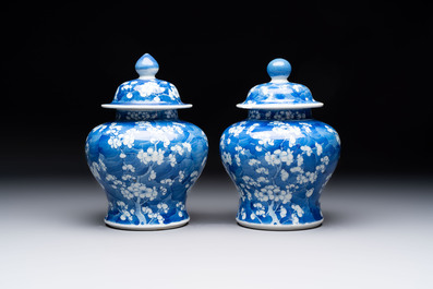 Two pairs of Chinese blue and white covered vases and a large covered vase, 19th C.