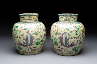 A pair of Chinese verte biscuit 'fish' jars and covers, 19th C.