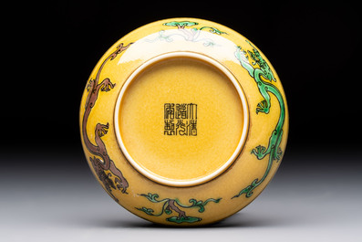 A Chinese yellow-ground aubergine and green-enamelled 'dragon' saucer, Daoguang mark and of the period