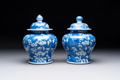 Two pairs of Chinese blue and white covered vases and a large covered vase, 19th C.