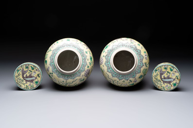 A pair of Chinese verte biscuit 'fish' jars and covers, 19th C.
