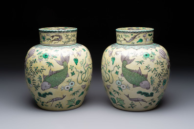 A pair of Chinese verte biscuit 'fish' jars and covers, 19th C.
