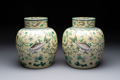 A pair of Chinese verte biscuit 'fish' jars and covers, 19th C.