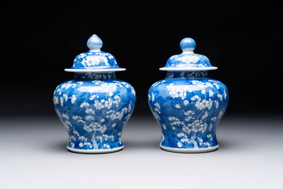 Two pairs of Chinese blue and white covered vases and a large covered vase, 19th C.