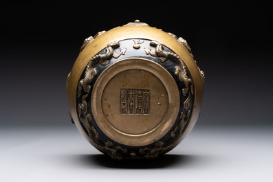 A Chinese bronze cylindrical censer with relief dragon design, Xuande mark, 18/19th C.