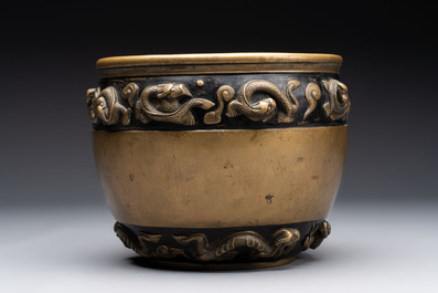 A Chinese bronze cylindrical censer with relief dragon design, Xuande mark, 18/19th C.