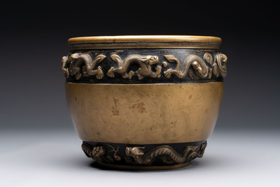 A Chinese bronze cylindrical censer with relief dragon design, Xuande mark, 18/19th C.