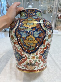 A Chinese English-decorated blue and white vase and cover, Kangxi