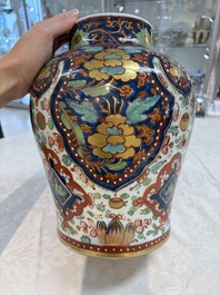 A Chinese English-decorated blue and white vase and cover, Kangxi