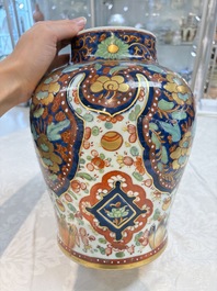 A Chinese English-decorated blue and white vase and cover, Kangxi